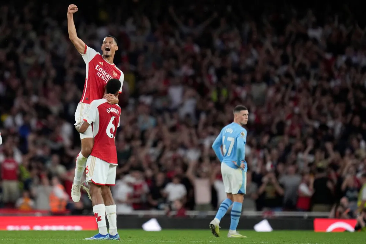 Arsenal's William Saliba, top, and Arsenal's Gabriel celebrate winning the English Premier League soccer match between Arsenal and Manchester City at the Emirates Stadium in London, on Oct. 8, 2023. (Kirsty Wigglesworth/AP Photo)