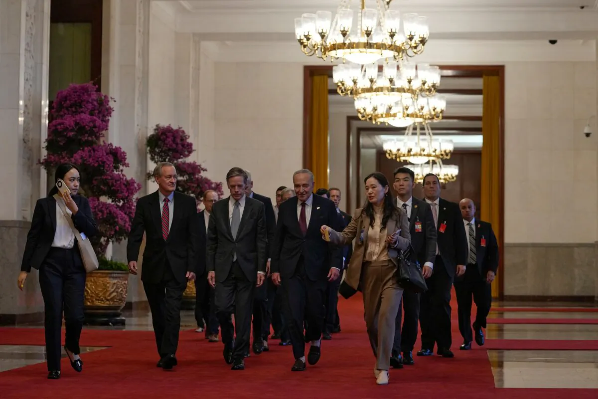 U.S. Senate Majority Leader Chuck Schumer (centre R) and his delegation walk to a bilateral meeting with Chinese leader Xi Jinping in Beijing on Oct. 9, 2023. (Andy Wong /AFP via Getty Images)