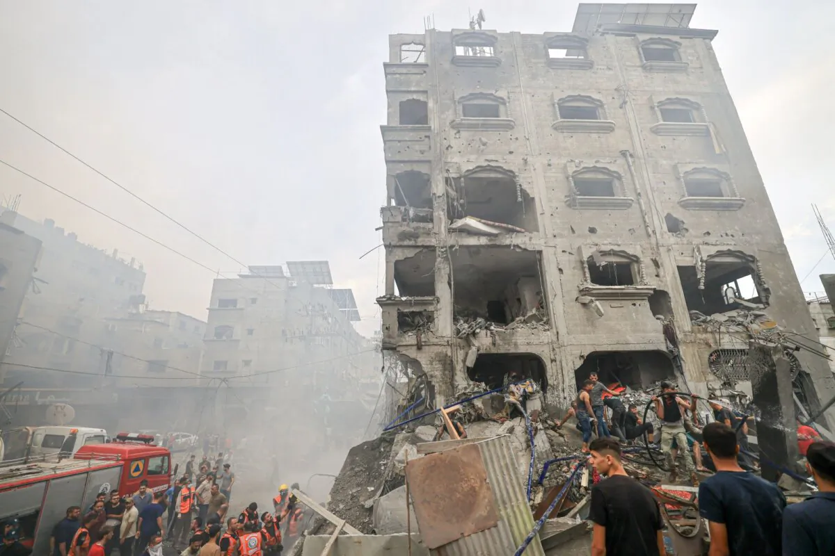 Palestinians search for survivors after an Israeli airstrike on buildings in the refugee camp of Jabalia in the Gaza Strip on Oct. 9, 2023. (Mahmud Hams/AFP via Getty Images)