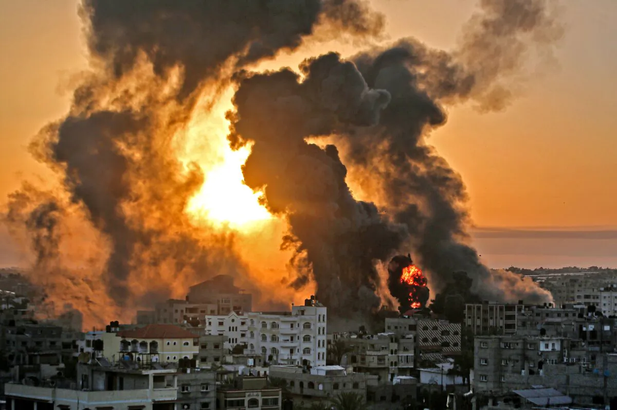 A fire rages at sunrise in Khan Yunish following an Israeli airstrike on Hamas targets in the southern Gaza strip, early on May 12, 2021. (Youssef Massoud/AFP via Getty Images)