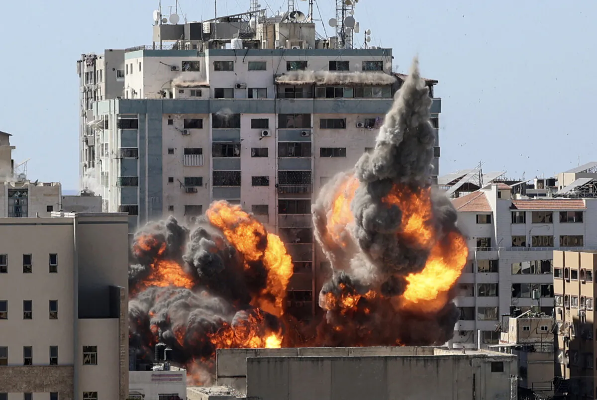 A ball of fire erupts from the Jala Tower as it is destroyed in an Israeli airstrike on Hamas targets in Gaza city, which is controlled by the Hamas terrorist group, on May 15, 2021. (Mahmud Hams/AFP via Getty Images)