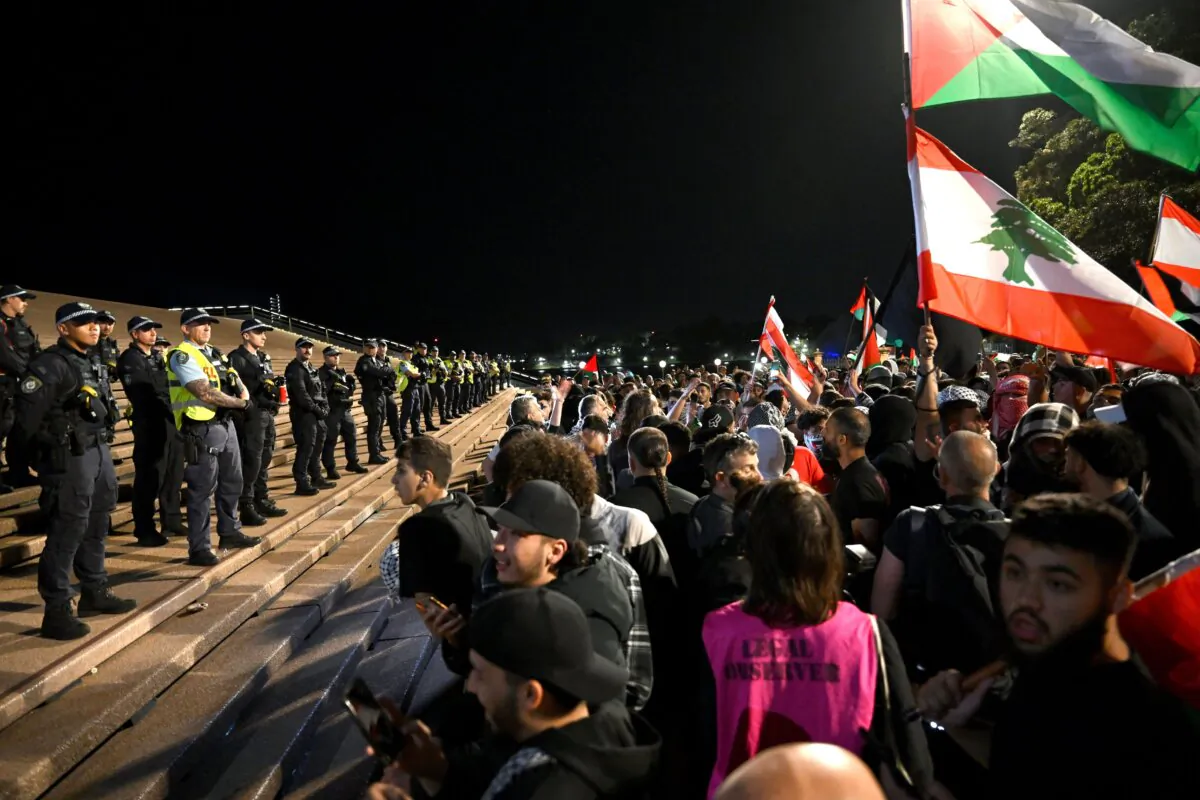 Police look on as participants of a Free Palestine rally react outside the Sydney Opera House in Sydney, Australia, on Oct. 9, 2023. (AAP Image/Dean Lewins)