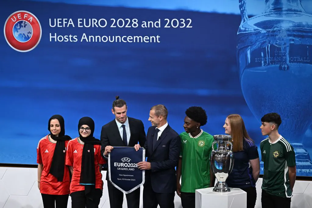 Former Real Madrid and Wales player Gareth Bale (3rdL), flanked by UEFA president Aleksander Ceferin (4thL), poses with fans after the United Kingdom and Ireland were elected to host the Euro 2028 fooball tournament during a ceremony at the UEFA headquarters in Nyon, Switzerland on Oct. 10, 2023. (Fabrice Coffrini/AFP via Getty Images)