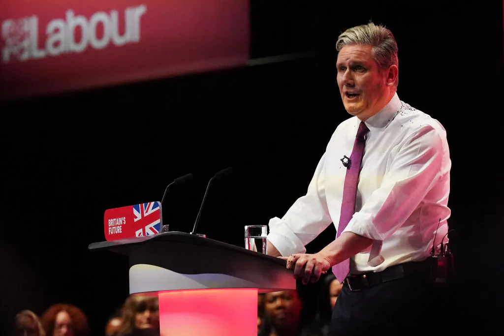 Labour Party leader Sir Keir Starmer delivers the leader's speech, covered in glitter after a protester stormed the stage on the third day of the Labour Party conference in Liverpool, England, on Oct. 10, 2023. (Ian Forsyth/Getty Images)
