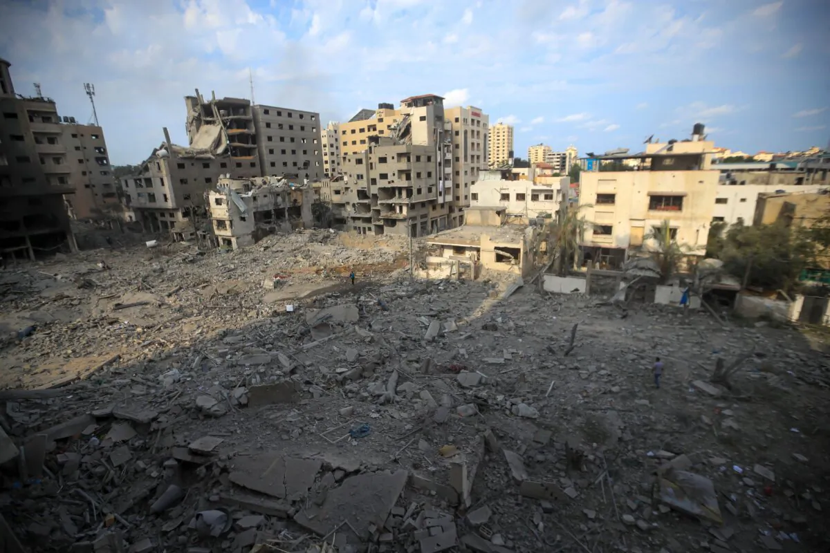 Palestinians inspect the destruction following Israeli airstrikes on Gaza City's al-Rimal district on Oct. 10, 2023. (Mohamed Zaanoun/Middle East Images/AFP via Getty Images)