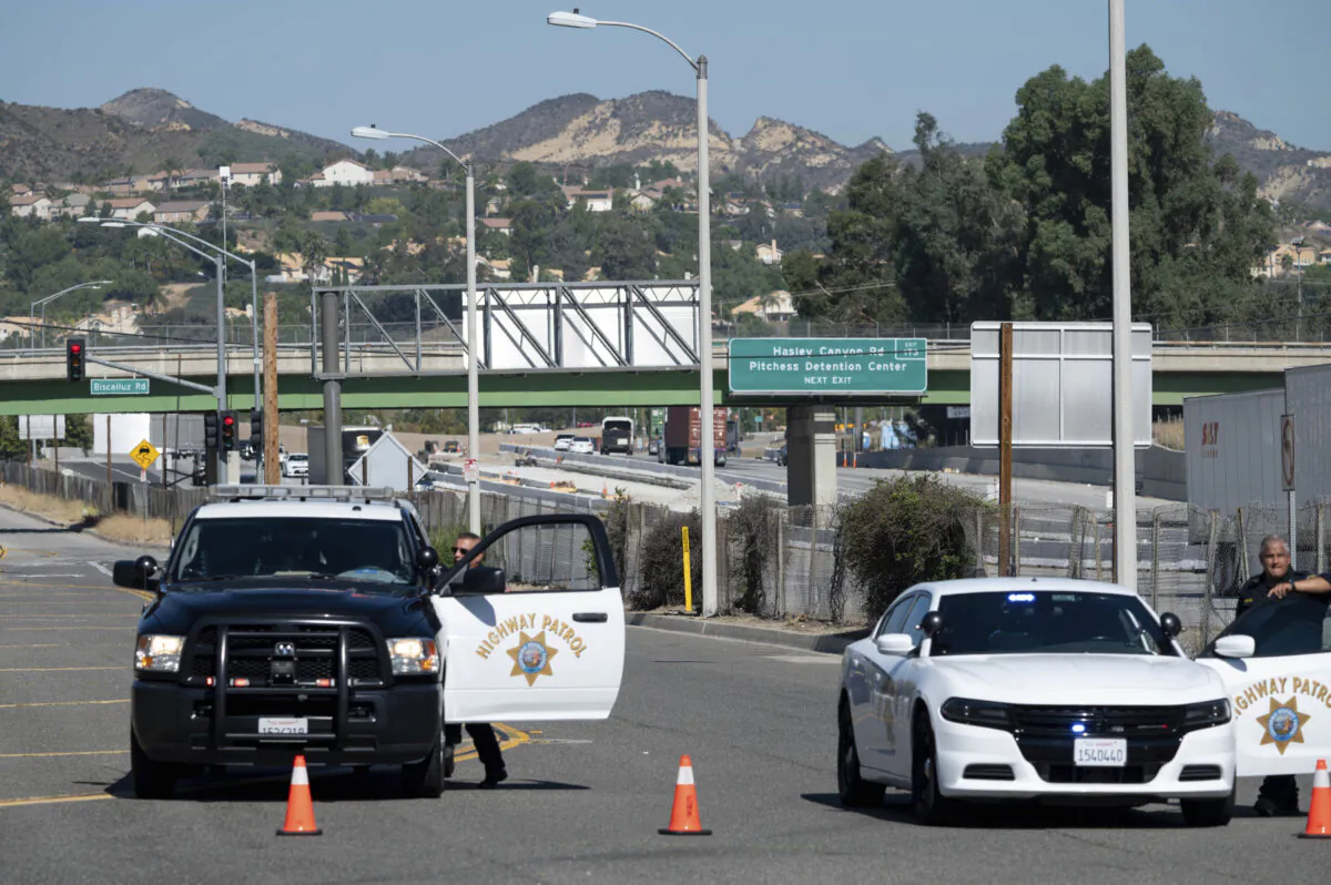 California Highway Patrol and sheriffs block off The Old Road with access to Pitchess Detention Center in Castaic, Calif, on Oct. 10, 2023. (David Crane/The Orange County Register via AP)