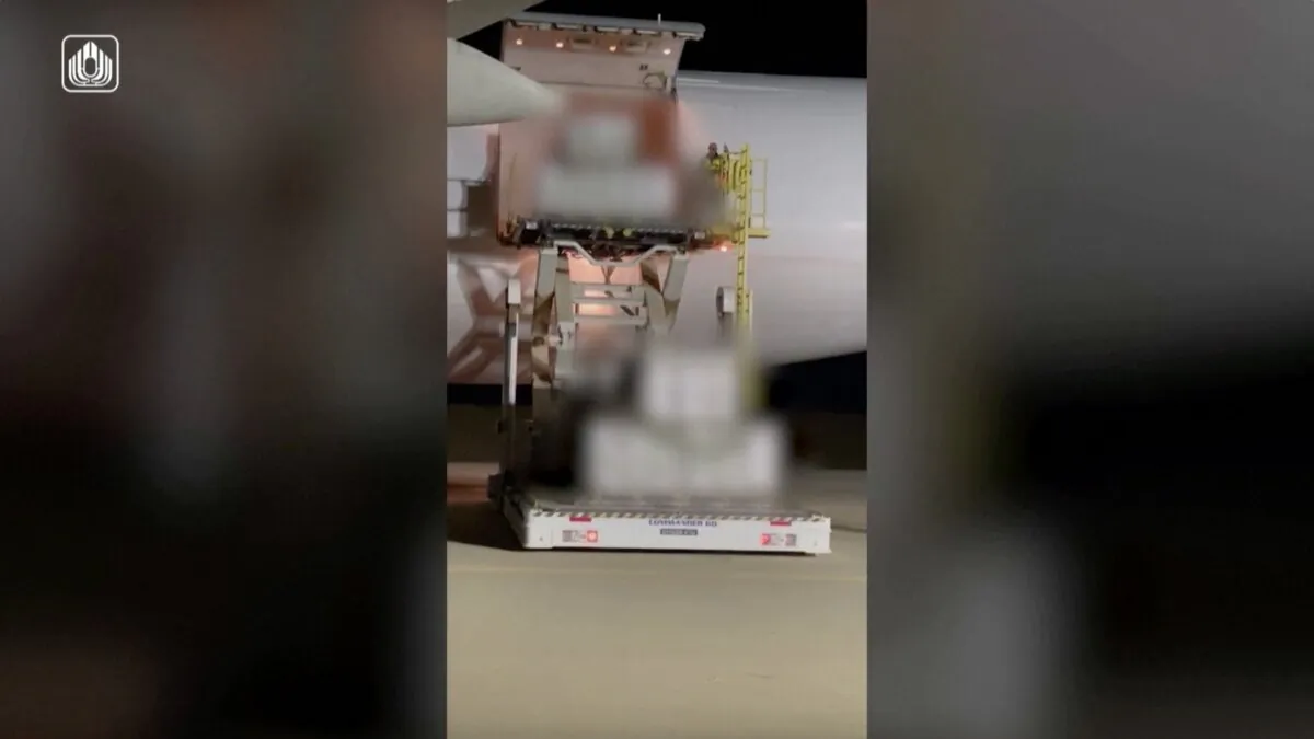 Shipment of ammunition sent from the United States being unloaded from a cargo plane in an unknown location in Israel on Oct. 11, 2023, in a still from video. (Israel Defense Ministry via Reuters/Screenshot via The Epoch Times)