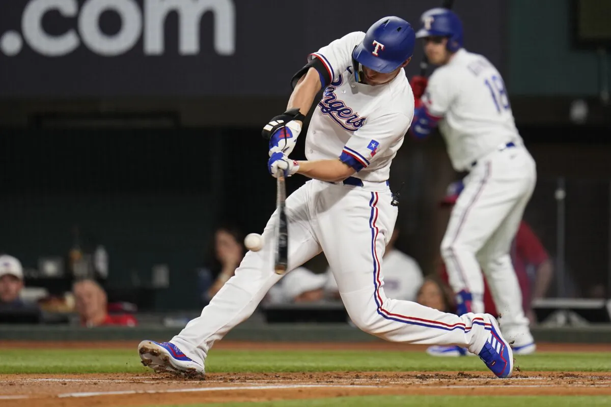 Texas Rangers' Corey Seager hits a solo home run in the first inning of Game 3 of a baseball AL Division Series against the Baltimore Orioles in Arlington, Texas, on Oct. 10, 2023. (Julio Cortez/AP Photo)