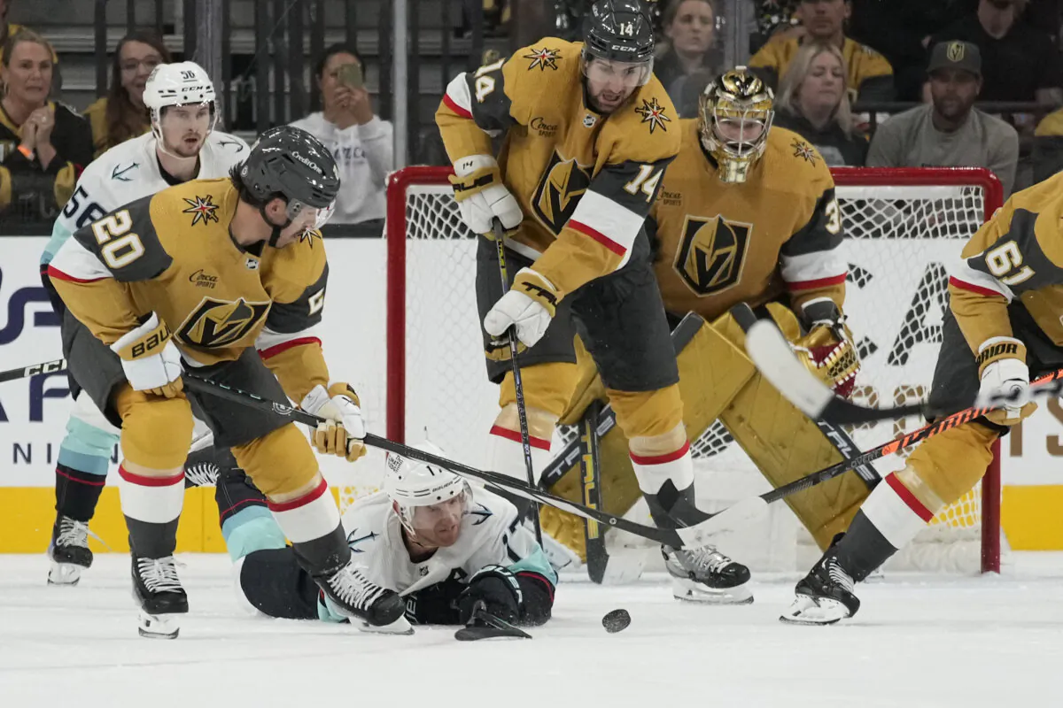 Seattle Kraken center Jaden Schwartz dives to try and knock the puck away from Vegas Golden Knights center Chandler Stephenson (20) during the second period of an NHL hockey game in Las Vegas on Oct. 10, 2023. (John Locher/AP Photo)