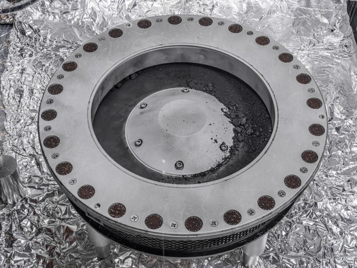 The outside of the Osiris-Rex sample collector with material from asteroid Bennu (middle R) in a photo provided on Oct. 11, 2023. (Erika Blumenfeld, Joseph Aebersold/NASA via AP)