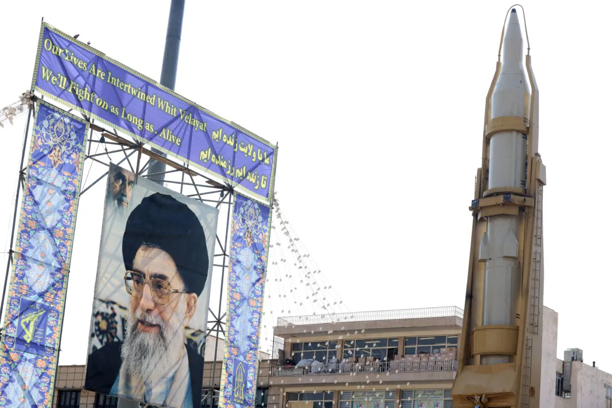 An Iranian surface-to-surface missile displayed next to a portrait of Iran's supreme leader, Ayatollah Ali Khamenei, in Tehran, Iran, on Sept. 27, 2023. (Atta Kenare/AFP via Getty Images)
