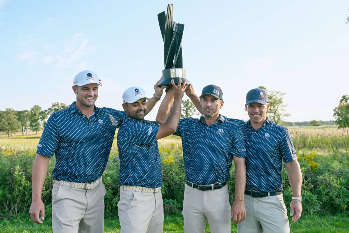 Bryson DeChambeau, Anirban Lahiri, Charles Howell III, and Paul Casey pose with the trophy after winning the LIV Golf Invitational - Chicago at Rich Harvest Farms in Sugar Grove, Illinois, on Sept. 24, 2023. (Quinn Harris/Getty Images)
