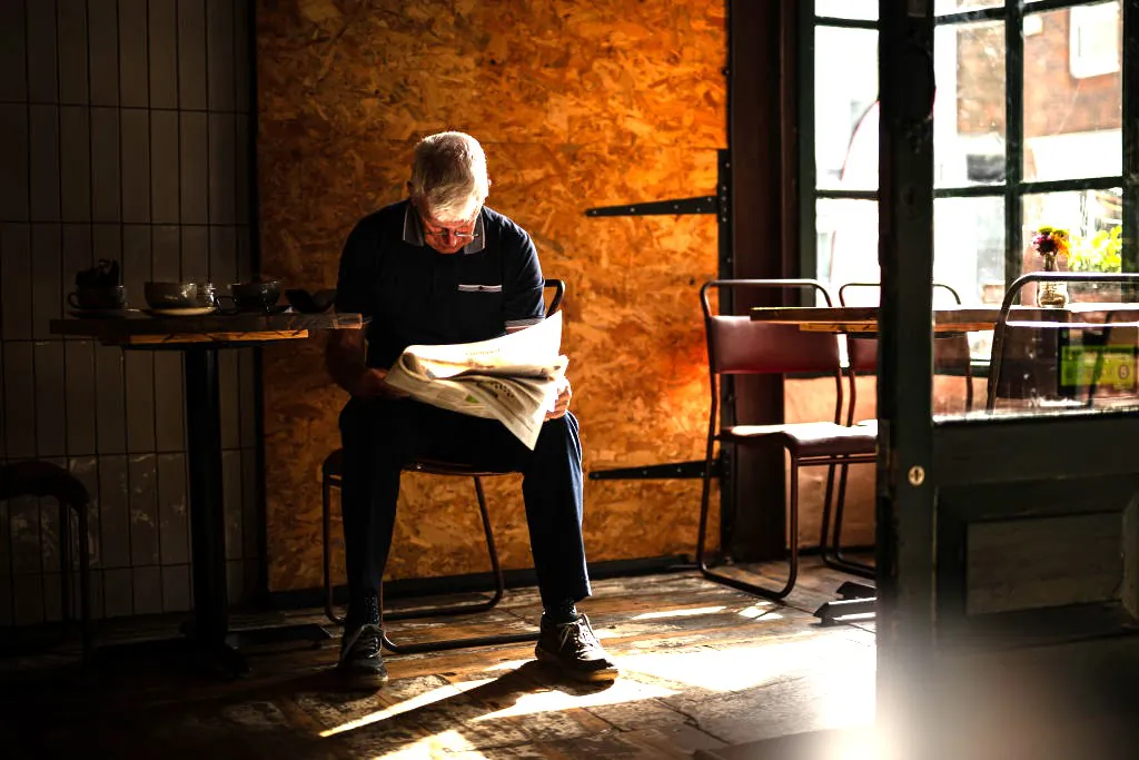 A man reads a newspaper in a cafe in Worthing, England, on Sept. 26, 2023. (Leon Neal/Getty Images)