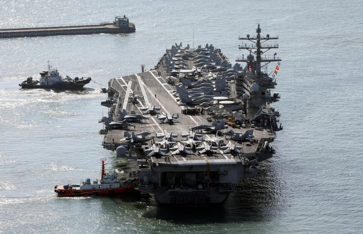 U.S. nuclear-powered aircraft carrier USS Ronald Reagan is escorted as it arrives in Busan, South Korea, on Oct. 12, 2023. (Kang Duck-chul/Yonhap via AP)