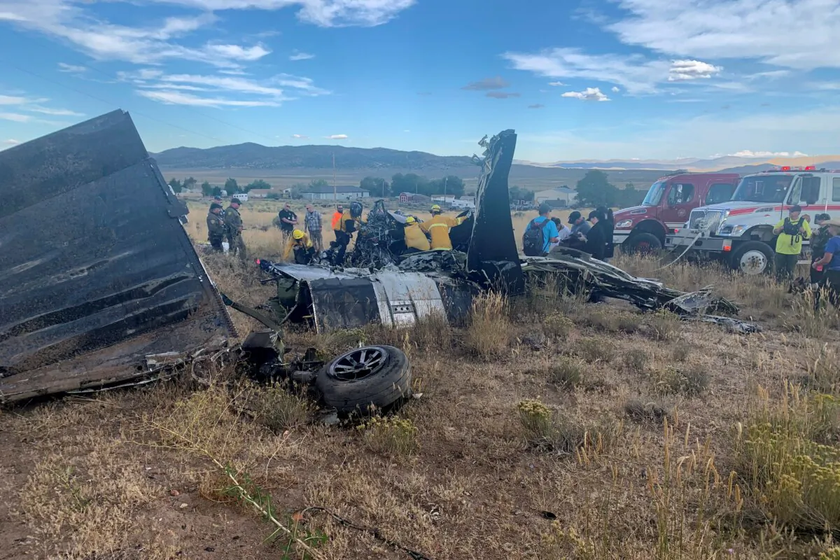 Members of Truckee Meadows Fire & Rescue and other officials look over aircraft wreckage in Reno, Nev., on Sept. 17, 2023. (Adam R. Mayberry/Truckee Meadows Fire & Rescue via AP )