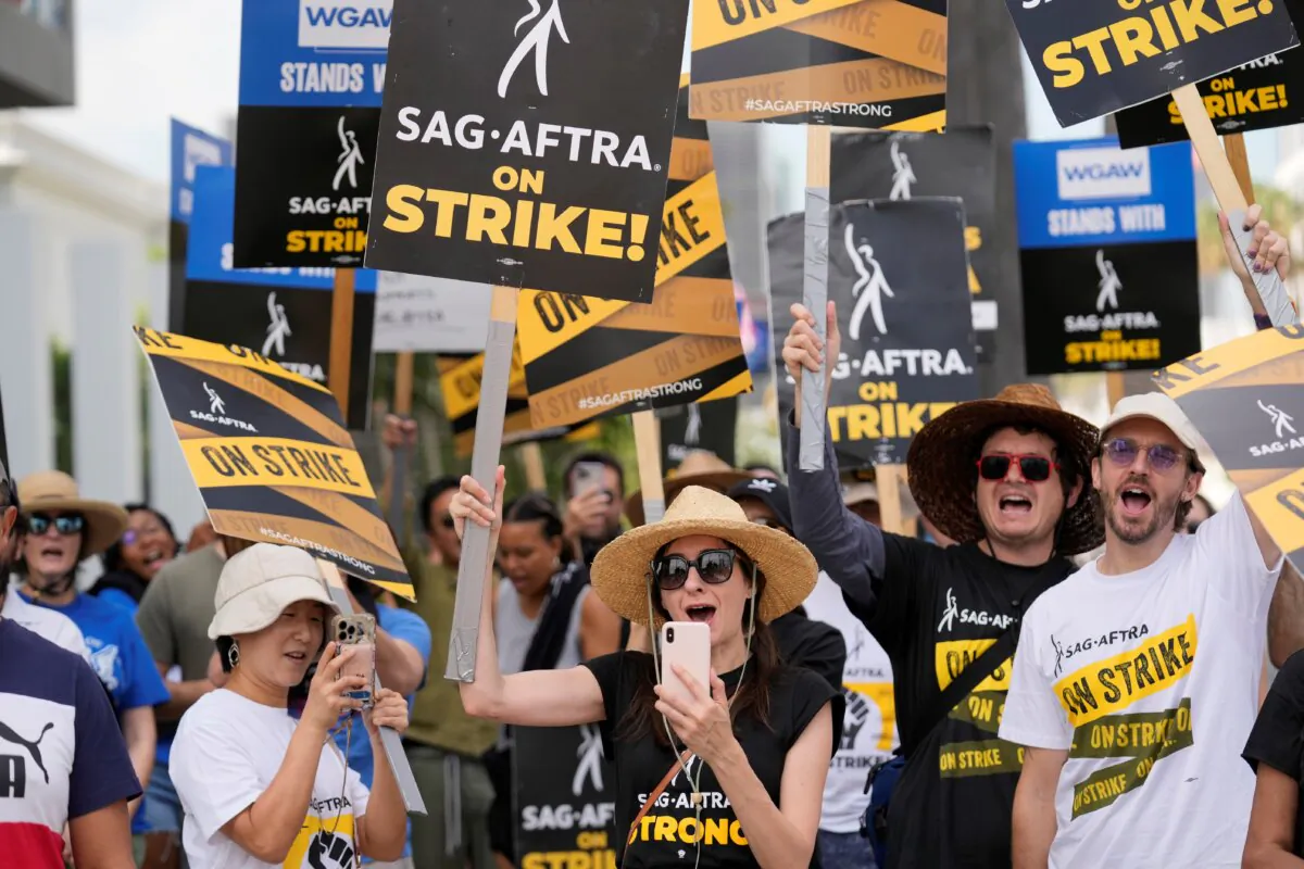 Picketers carry signs on the picket line outside Netflix in Los Angeles on Sept. 27, 2023. (Chris Pizzello/AP Photo)