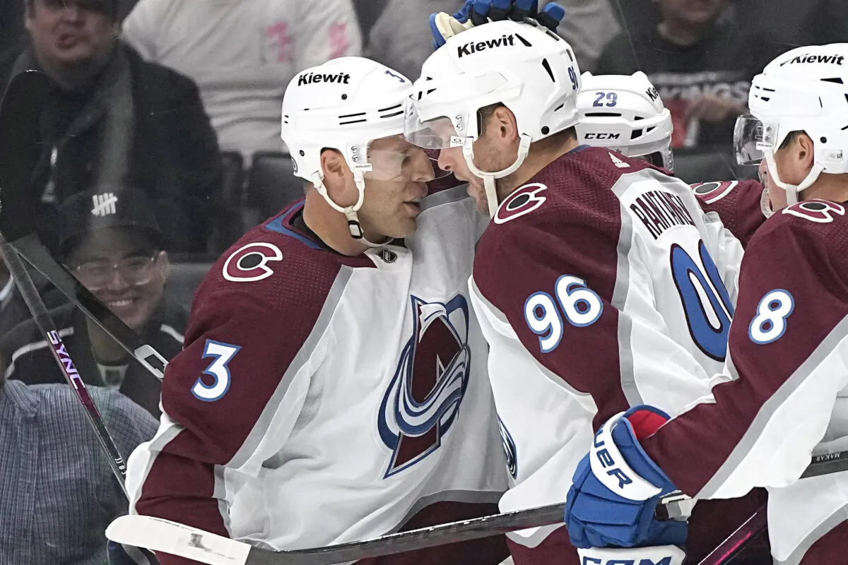 Colorado Avalanche right wing Mikko Rantanen (C) celebrates his goal with defenseman Jack Johnson (L) during the third period of an NHL hockey game against the Los Angeles Kings in Los Angeles on Oct. 11, 2023. (Mark J. Terrill/AP Photo)