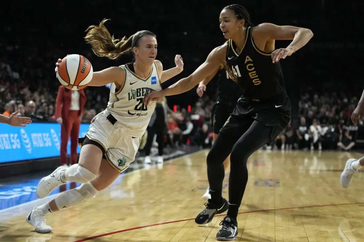 New York Liberty guard Sabrina Ionescu (20) drives against Las Vegas Aces center Kiah Stokes (41) during the first half in Game 2 of a WNBA basketball final playoff series in Las Vegas on Oct. 11, 2023. (John Locher/AP Photo)