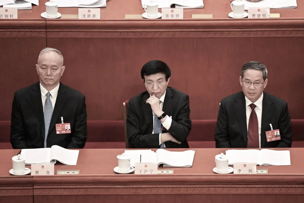 (L–R) Politburo Standing Committee members Cai Qi, Wang Huning, and Li Qiang attend the second plenary session of China's rubber-stamp legislature at the Great Hall of the People in Beijing on March 7, 2023. (Greg Baker/AFP via Getty Images)