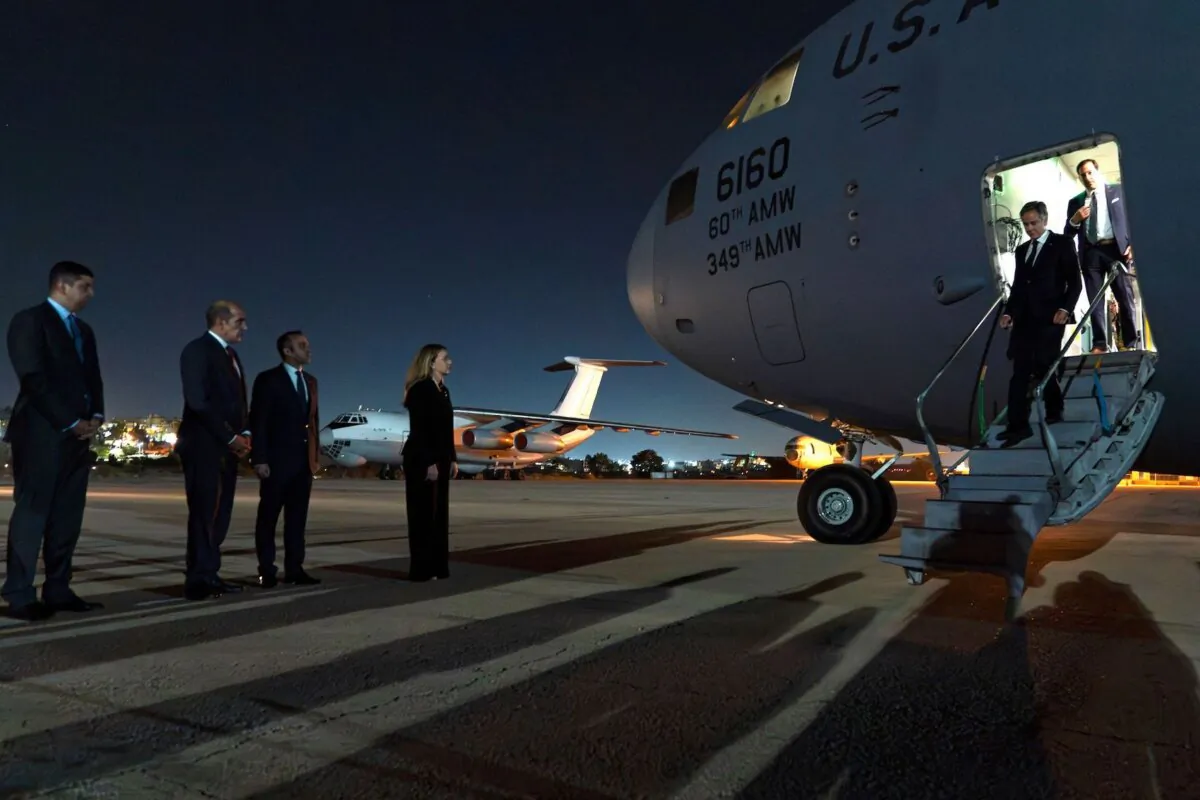 U.S. Secretary of State Antony Blinken (R) steps off a plane upon arrival to Amman, Jordan, on Oct. 12, 2023. Mr. Blinken vowed unwavering U.S. support for Israel in its war on Hamas during a visit Oct. 12, 2023. Mr. Blinken was to visit Saudi Arabia, Egypt, the UAE, Qatar and Jordan to put pressure on Hamas and secure the release of hostages, told reporters later the images were "new evidence of depravity and the inhumanity of Hamas". (Jacquelyn Martin/POOL/AFP)