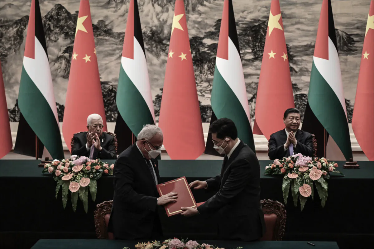 Palestinian Foreign Minister Riyad Al-Maliki (front L) attends a signing ceremony with Chinese Foreign Minister Qin Gang (front R) as Palestinian President Mahmoud Abbas (rear L) and Chinese leader Xi Jinping (rear R) applaud at the Great Hall of the People in Beijing on June 14, 2023. (Jade Gao/Pool/Getty Images)