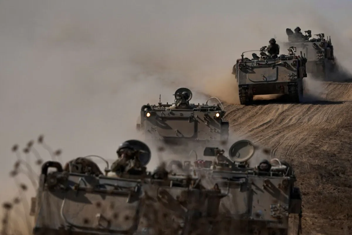 Israeli armored personnel carriers head towards the Gaza Strip border in southern Israel on Oct.13, 2023. (Ariel Schalit/AP Photo)