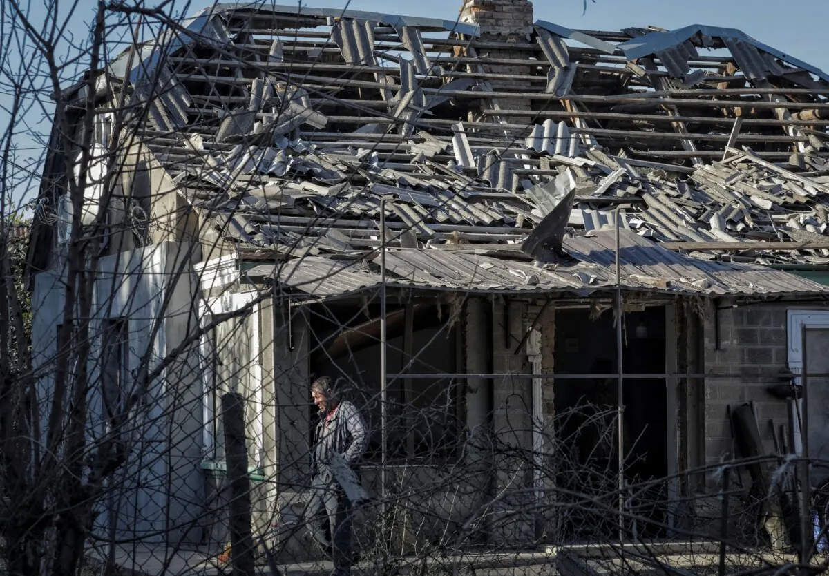 A local resident is seen outside a house damaged by a Russian drone strike in Izmail, Odesa region, Ukraine, on Oct. 12, 2023. (Nina Liashonok/Reuters)