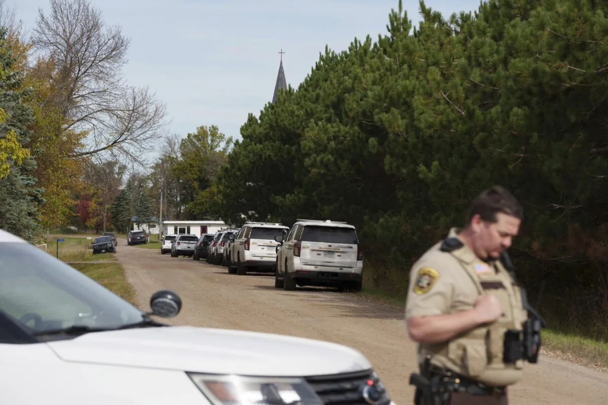 A Benton County sheriff establishes a security perimeter at the intersection of 186th Avenue NE and Glendorado Road NE near Princeton, Minn., on Oct. 10, 2023, following a "critical incident." (Tim Evans/Minnesota Public Radio via AP)