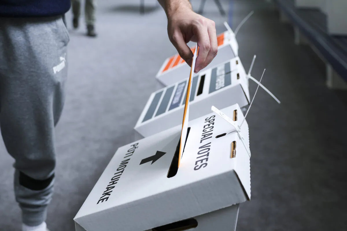 A voter casts a special vote during election day at Johnsonville School on Oct. 14, 2023 in Wellington, New Zealand. Hagen Hopkins/Getty Images)