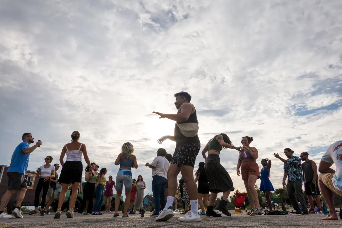 Participants dance at sunset during the Natural High alcohol-free party at Elysian Park on Sept. 9, 2023, in Los Angeles. (Myung J. Chun/Los Angeles Times/TNS)