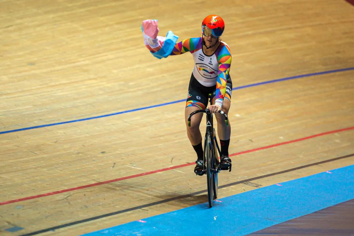 Canadian transgender cyclist Rachel McKinnon carries a flag while celebrating winning a race during the 2019 UCI Track Cycling World Masters Championship, in Manchester, England, on Oct. 19, 2019. (Oli Scarff/AFP via Getty Images)