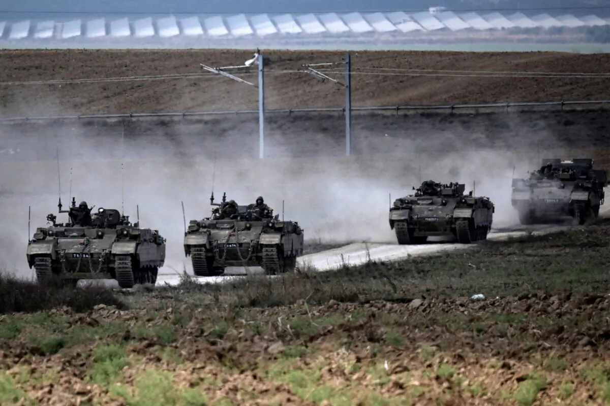 A column of Israeli army military armored vehicles moves near the Gaza border in southern Israel on Oct. 14, 2023. (Aris Messinis/AFP via Getty Images)