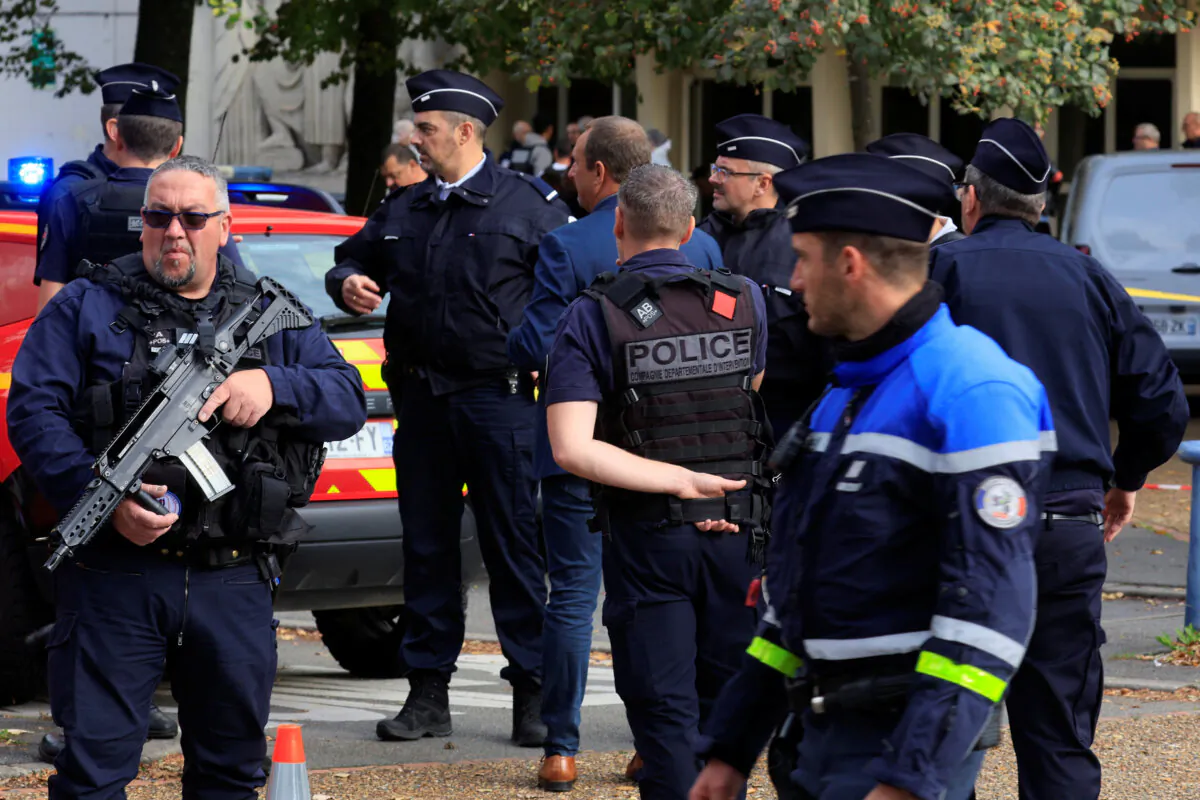 French police secure the area after a teacher was killed and several people injured in a knife attack at the Lycee Gambetta-Carnot high school in Arras, northern France, on Oct. 13, 2023. (Pascal Rossignol/Reuters)