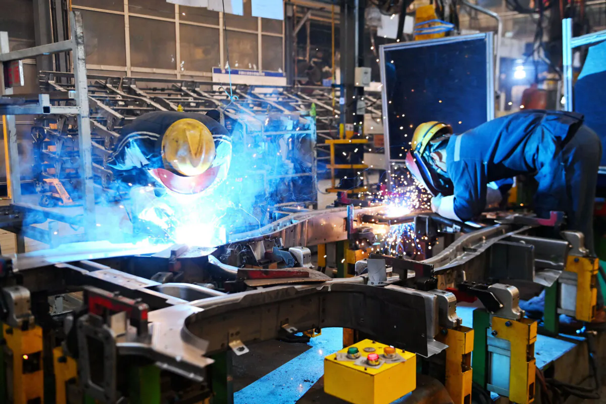 Employees work at an assembly line of a Wuling Motors factory in Qingdao, Shandong Province, China, on March 1, 2023. (STR/AFP via Getty Images)