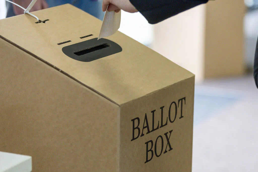 A vote is put into a ballot box at a polling center at St Kilda Primary School in Melbourne, Australia, on Oct. 14, 2023. (Asanka Ratnayake/Getty Images)