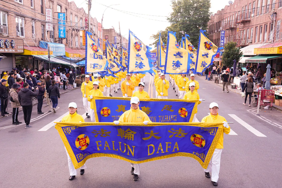 Falun Gong practitioners walk in a parade highlighting the Chinese regime's persecution of their faith, in Brooklyn, N.Y., on Oct. 15, 2023. (Larry Dye/The Epoch Times)