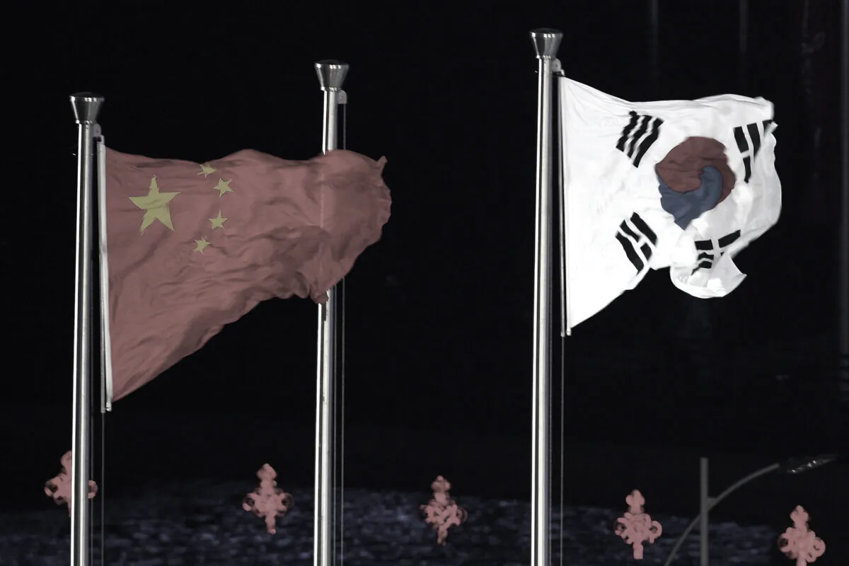 The flags of China and South Korea are displayed side-by-side during the Closing Ceremony at Haixinsha Square on day fifteen of the 16th Asian Games Guangzhou 2010 in Guangzhou, China, on Nov. 27, 2010. (Feng Li/Getty Images)