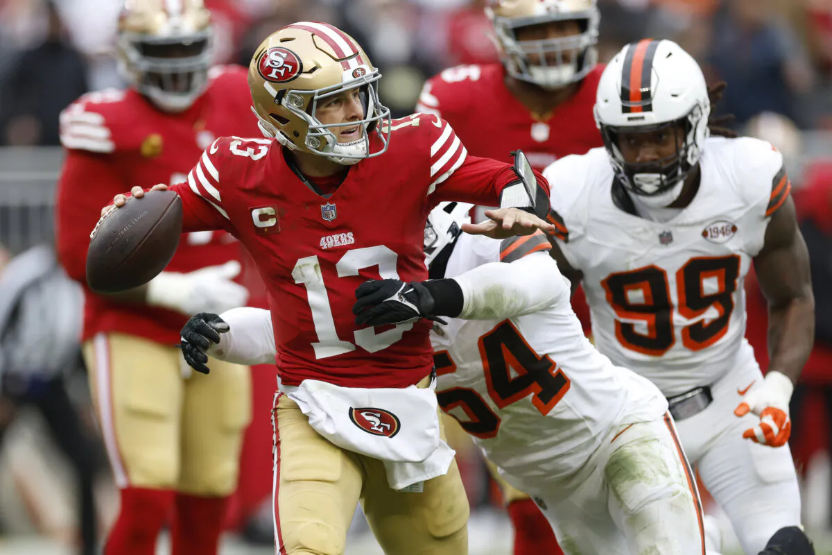 San Francisco 49ers quarterback Brock Purdy (13) is pressured by Cleveland Browns defensive end Ogbo Okoronkwo (54) during the second half of an NFL football game in Cleveland on Oct. 15, 2023. (Ron Schwane/AP Photo)