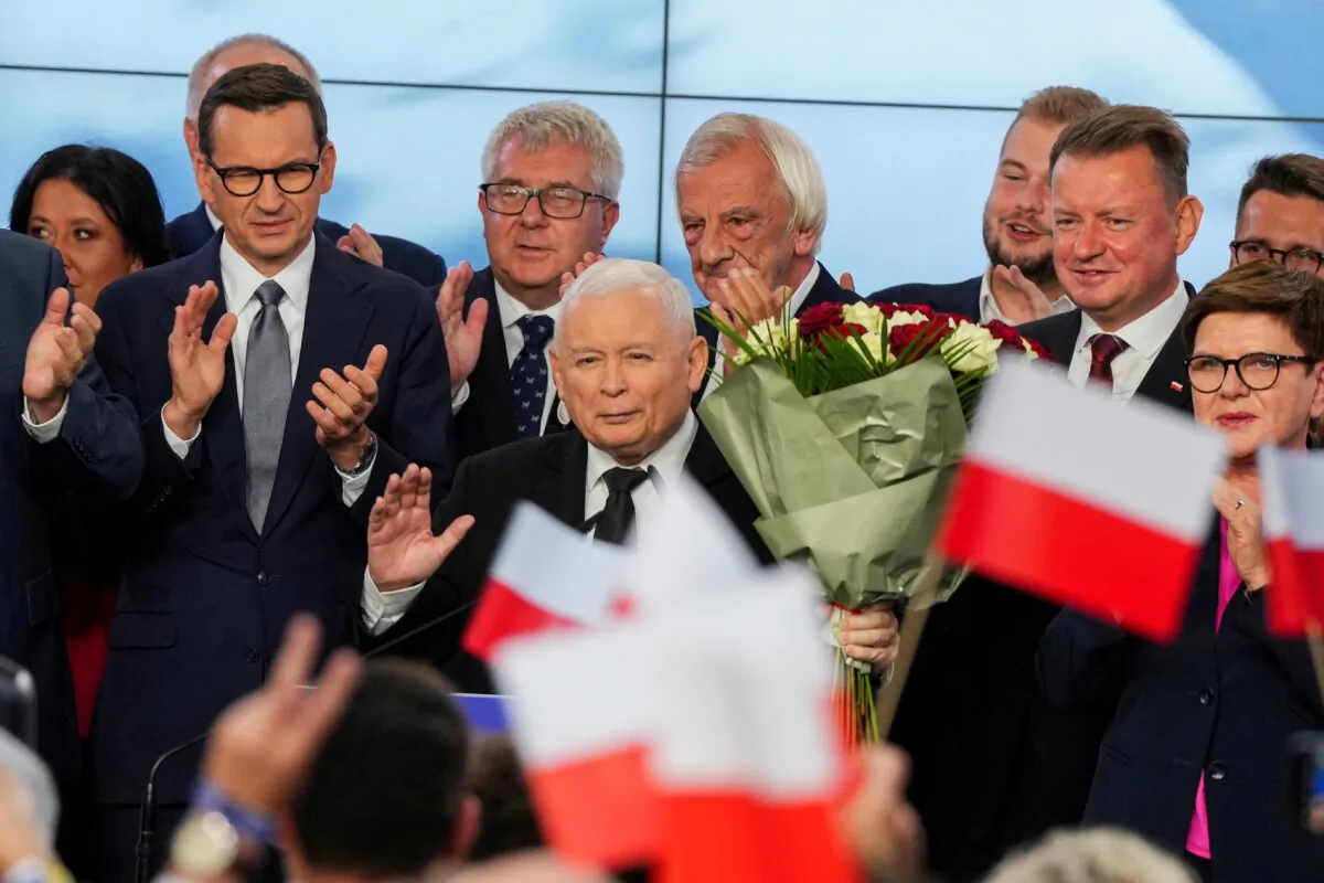 Leader of Poland's ruling conservative Law and Justice (PiS) party Jaroslaw Kaczynski, holds flowers during a speech after the exit poll results are announced in Warsaw, Poland, on Oct. 15, 2023. (Aleksandra Szmigiel/Reuters)