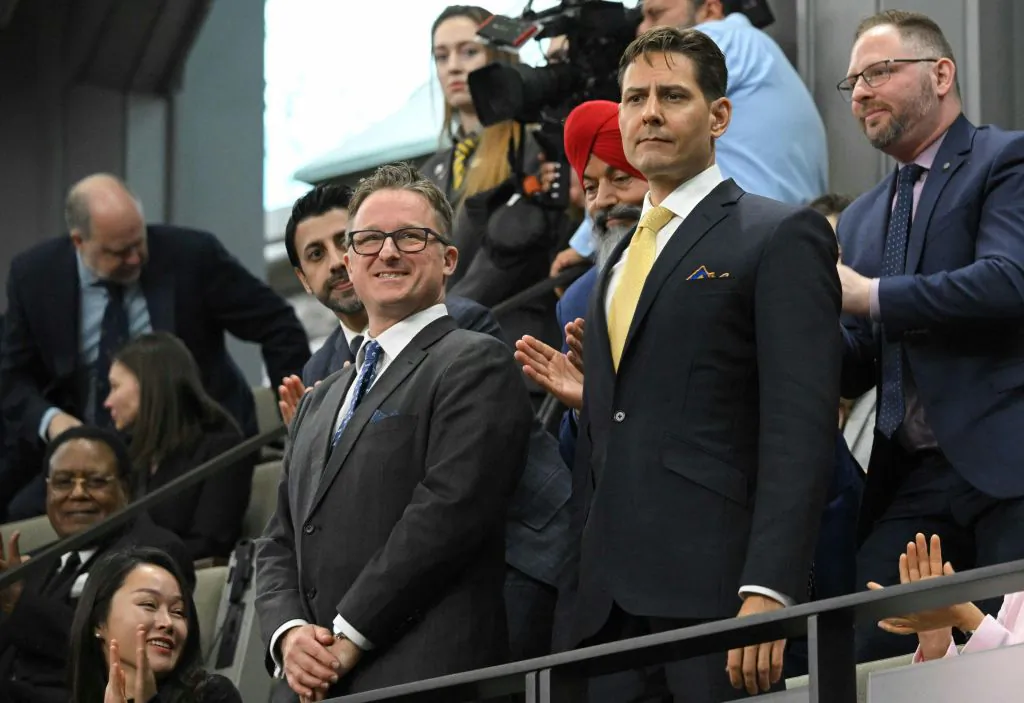 Canadians Michael Kovrig and Michael Spavor stand as they are recognized before an address from U.S. President Joe Biden in the Canadian House of Commons on Parliament Hill in Ottawa, Canada, on Mar. 24, 2023. (Mandel Ngan/POOL/AFP via Getty Images)