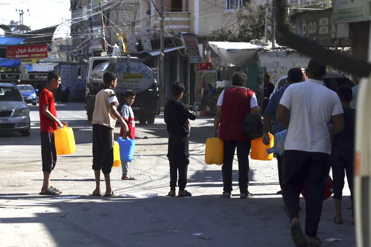 Palestinians queue for water at the Rafah refugee camp, in the south of the Gaza Strip, on Oct. 15, 2023. (Mohammed Abed/AFP via Getty Images)
