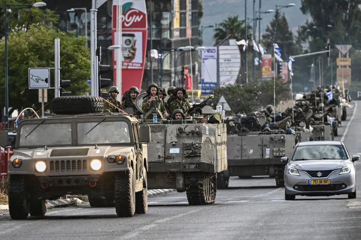 Israeli soldiers patrol in armoured personnel carriers at an undisclosed position in northern Israel near the border with Lebanon on Oct.15, 2023. (Aris Messinis/AFP via Getty Images)