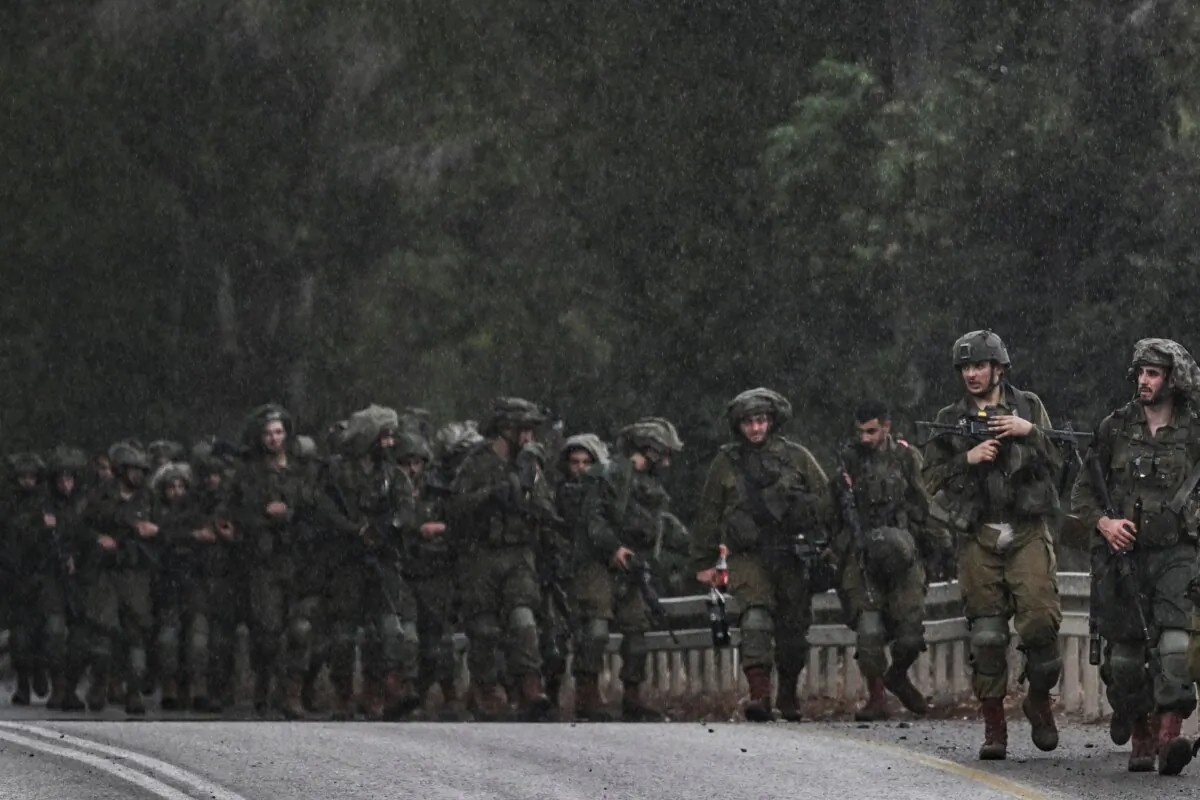 Israeli army soldiers patrol at an undisclosed position in northern Israel near the border with Lebanon on Oct. 15, 2023. (Aris Messinis/AFP via Getty Images)