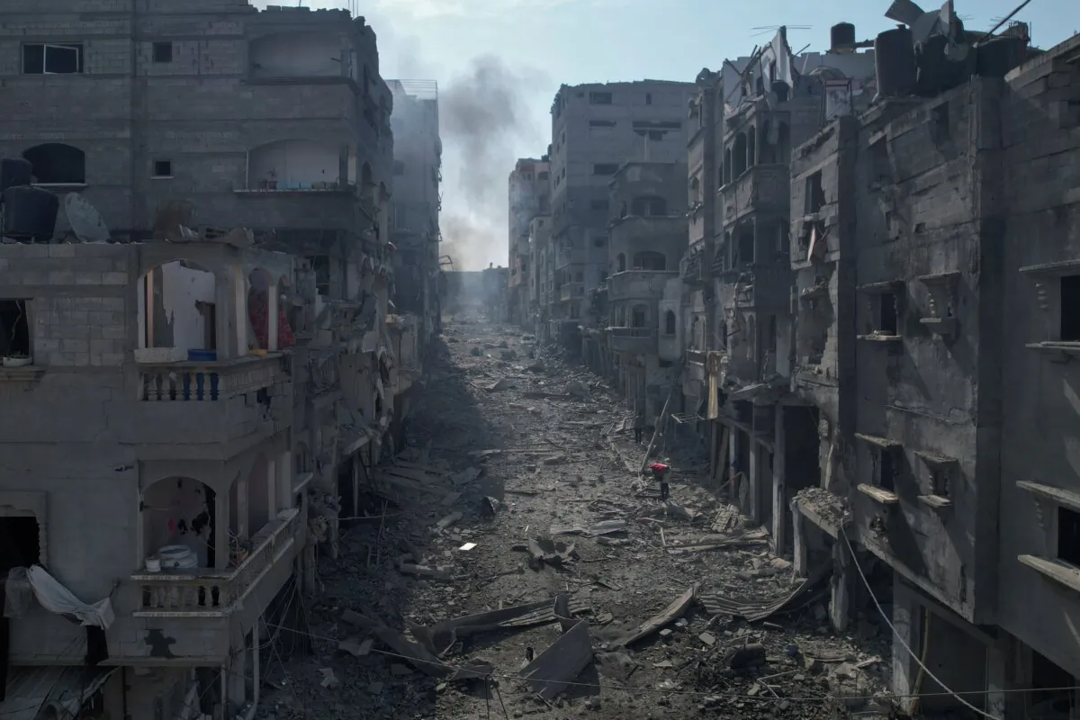 Rubble litters a street between smoldering buildings hit by an Israeli airstrike in Jabaliya, Gaza Strip, on Oct. 11, 2023. (Hatem Moussa/AP Photo)