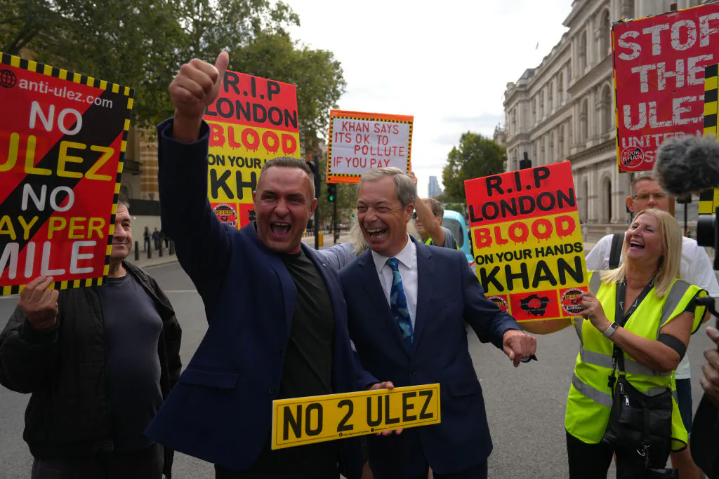 Noel Willcox (L), a scaffolder who successfully challenged his ULEZ fines poses with Nigel Farage (R) at the Stop ULEZ protest at Parliament Square in London, on August 29, 2023. (Photo by Carl Court/Getty Images)
