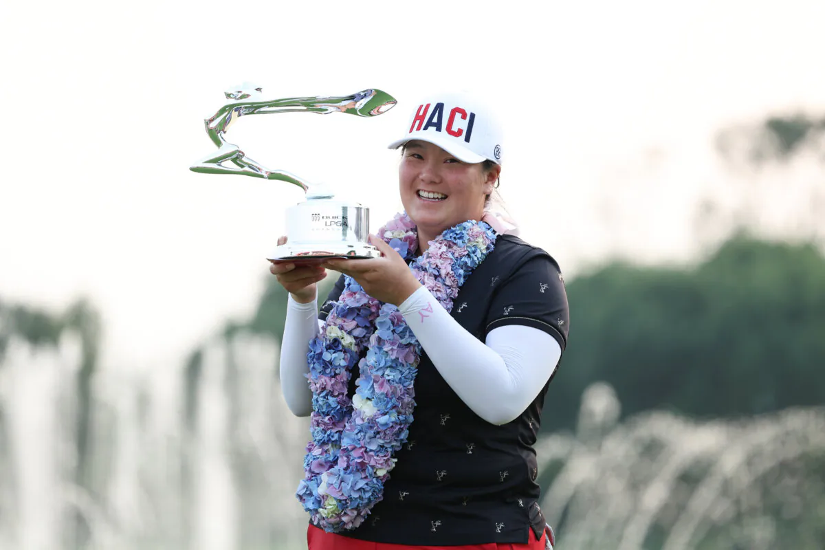 Angel Yin of Arcadia, Calif., poses with the Buick LPGA Shanghai Champion Trophy after winning the Buick LPGA Shanghai in Shanghai on Oct. 15, 2023. (Zhe Ji/Getty Images)