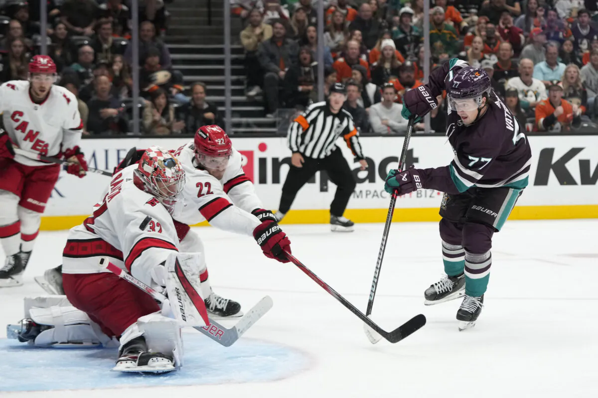 Carolina Hurricanes goalie Antti Raanta (32) makes a save against Anaheim Ducks' Frank Vatrano (77) during the third period of an NHL hockey game in Anaheim, Calif., Oct. 15, 2023. (Jae C. Hong/AP Photo)