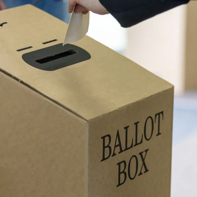 A person puts their vote into a ballot box at a polling centre at St Kilda Primary school in Melbourne, Australia, on Oct. 14, 2023. A referendum for Australians to decide on an indigenous voice to parliament was held on Oct. 14, 2023 and compelled all Australians to vote by law. (Asanka Ratnayake/Getty Images)
