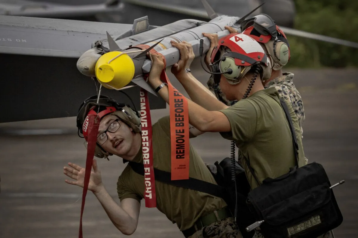 U.S. marines load an AIM-9 Sidewinder missile into an F/A-18 Hornet fighter jet as they take part in the bi-annual Marine Aviation Support Activity (MASA) 23 at the airport of a former U.S. naval base, in Subic Bay, Philippines, on July 13, 2023. (Ezra Acayan/Getty Images)