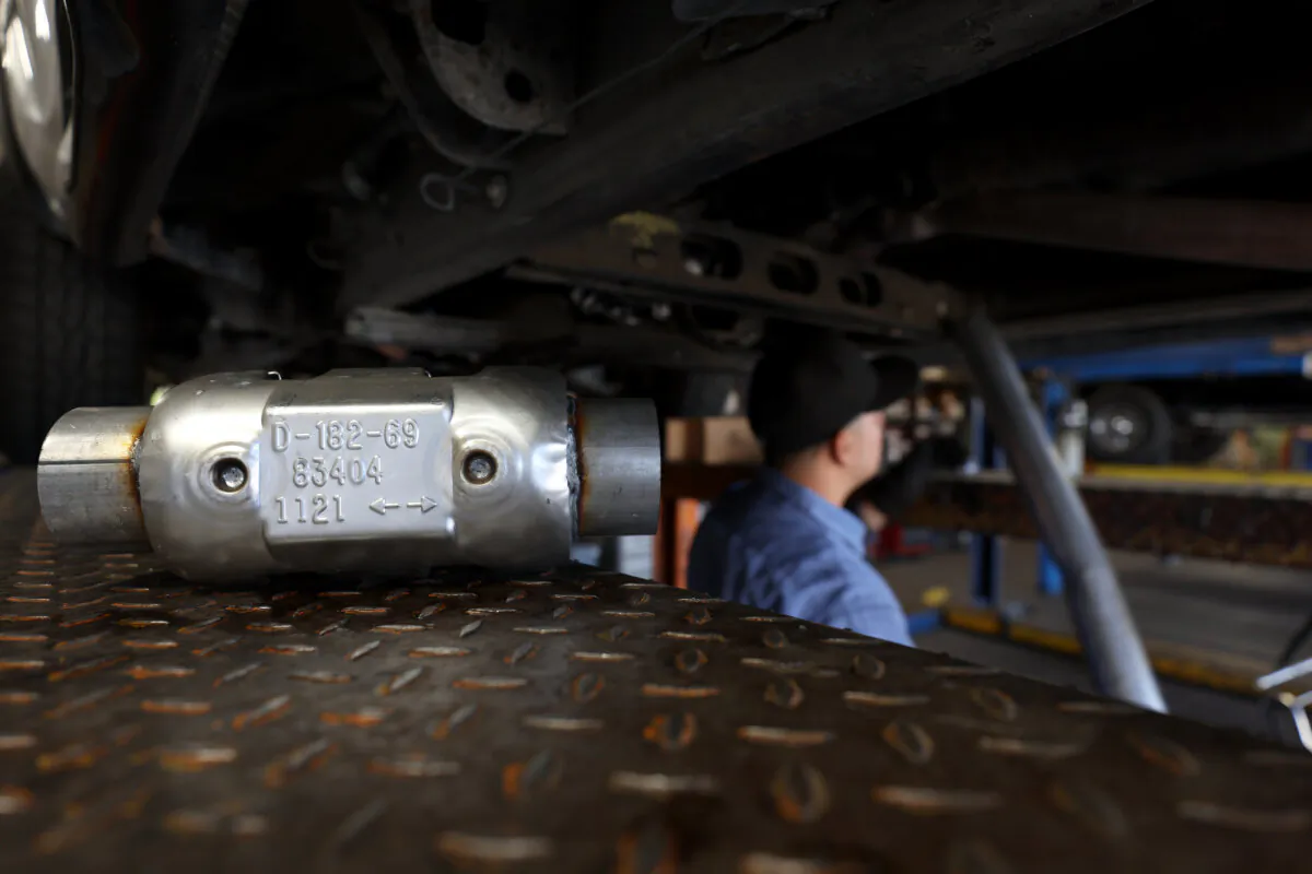 A brand new catalytic converter sits on a car lift at Johnny Franklin's Muffler in San Rafael, Calif., on July 11, 2022. Thefts of catalytic converters are surging across the nation as thieves seek out precious metals like platinum, palladium and rhodium that fill the inside of the antipollution car part. (Justin Sullivan/Getty Images)